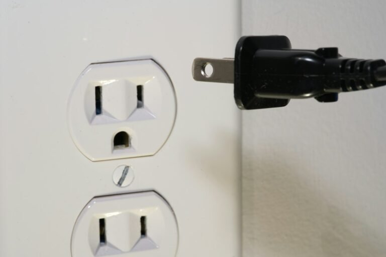 Close-up of electrical socket and plug illustrating generator outlet safety