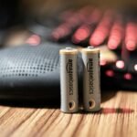 Battery on a wooden surface illustrating battery-capacity label comparisons