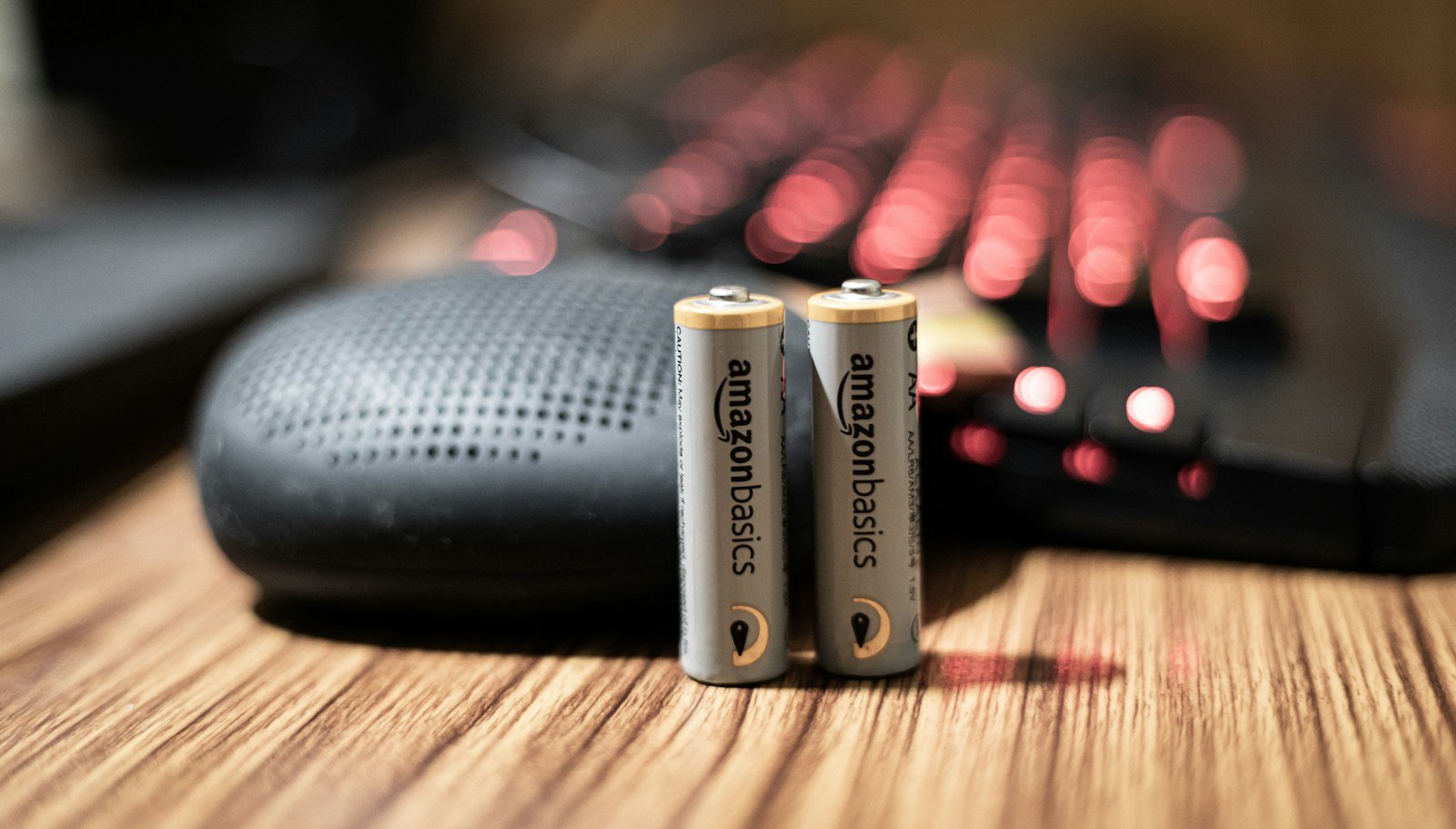 Battery on a wooden surface illustrating battery-capacity label comparisons