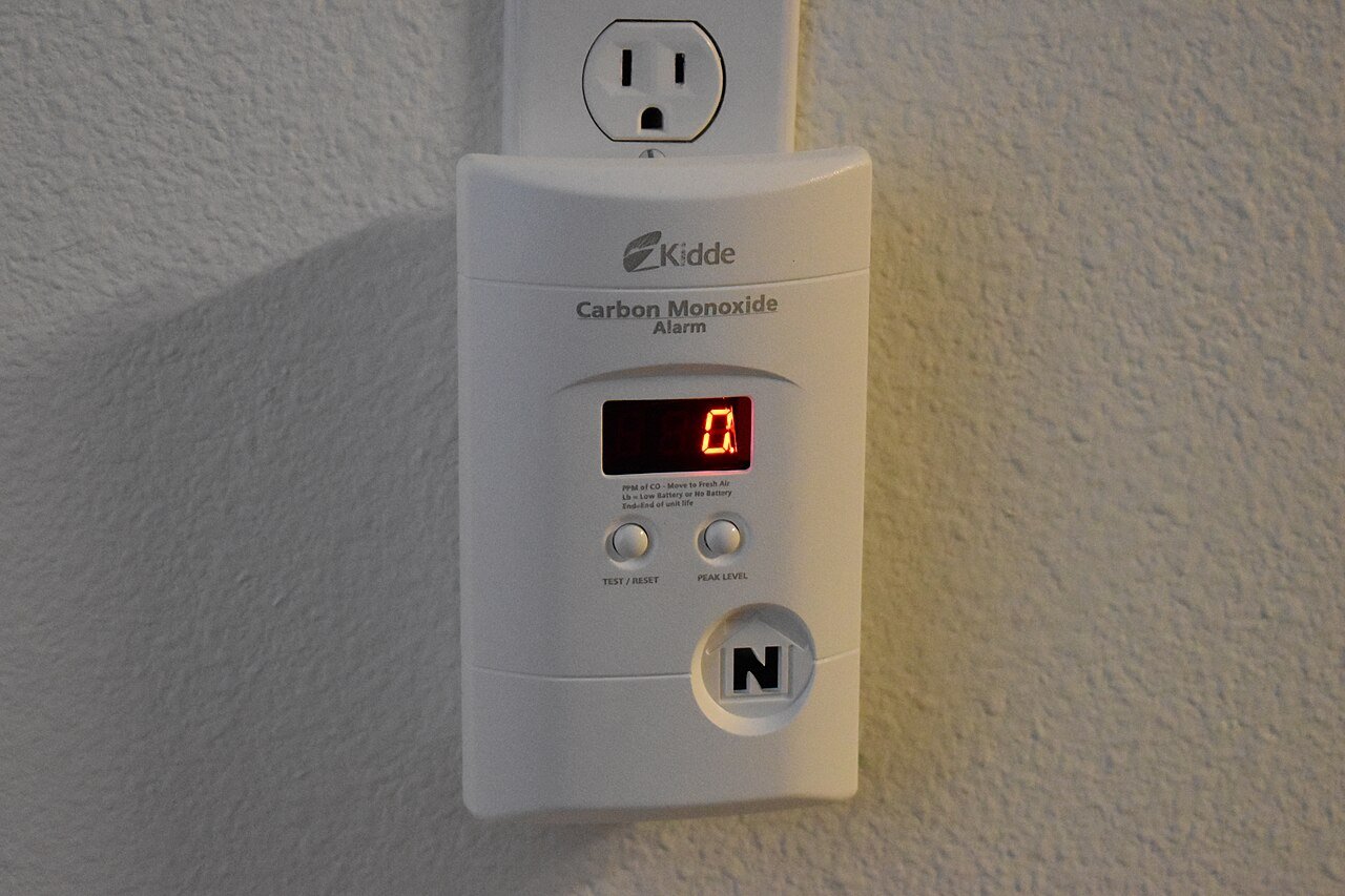 Carbon monoxide alarm with a digital display and test button
