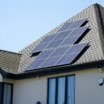 Solar panels installed on a residential rooftop illustrating the cost of solar power with home battery storage