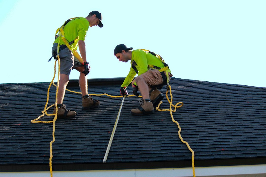 Solar installers working on a rooftop array illustrating safe series solar panel wiring and installation
