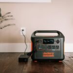 Original Jackery Explorer 1500 on a table with its charger, illustrating power-station charging
