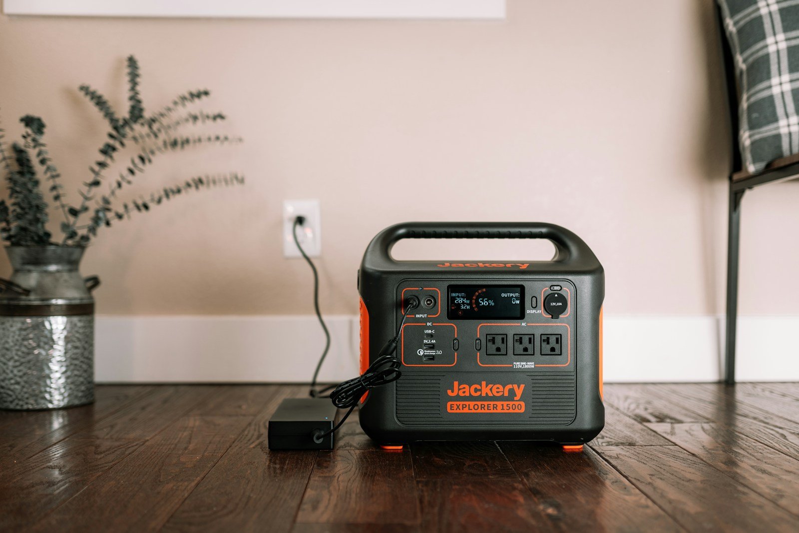 Original Jackery Explorer 1500 on a table with its charger, illustrating power-station charging