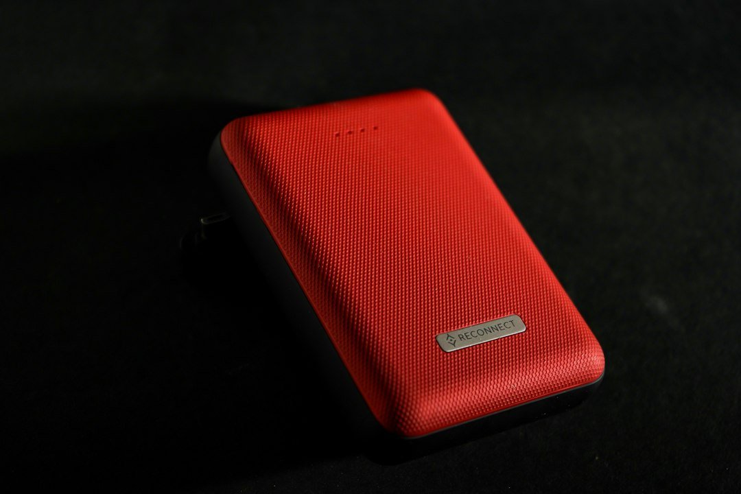 Portable power bank showing input and output ports for pass-through charging checks