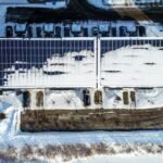 Rooftop solar panels partially covered with snow during winter weather