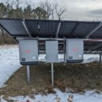 Solar power system with photovoltaic panels and inverters, illustrating equipment used alongside home battery storage