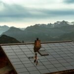 Rooftop solar panels under a cloudy sky