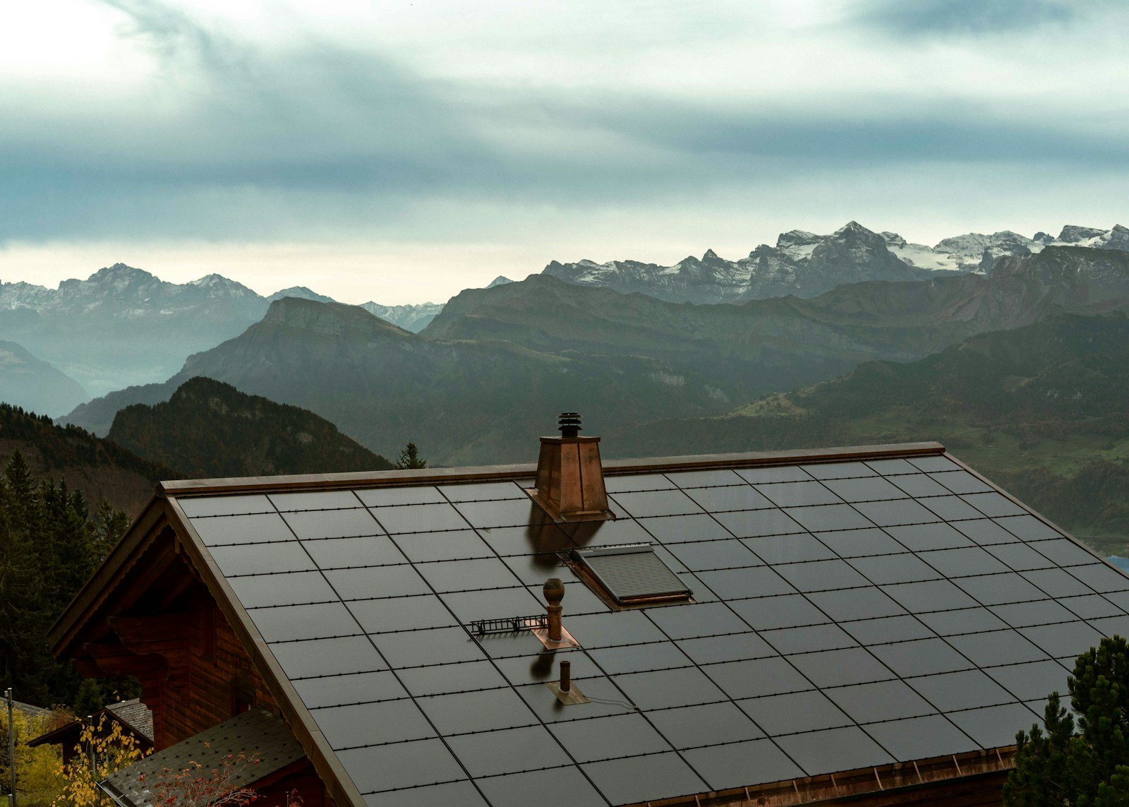 Rooftop solar panels under a cloudy sky