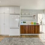 a white refrigerator freezer sitting inside of a kitchen