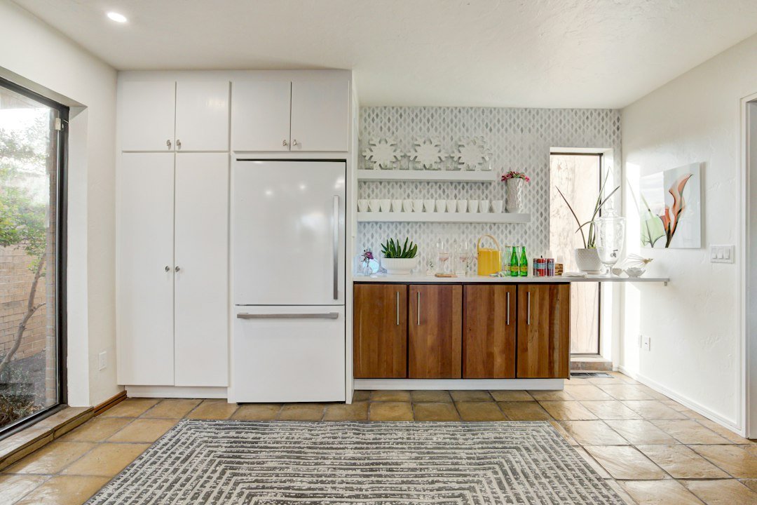 a white refrigerator freezer sitting inside of a kitchen